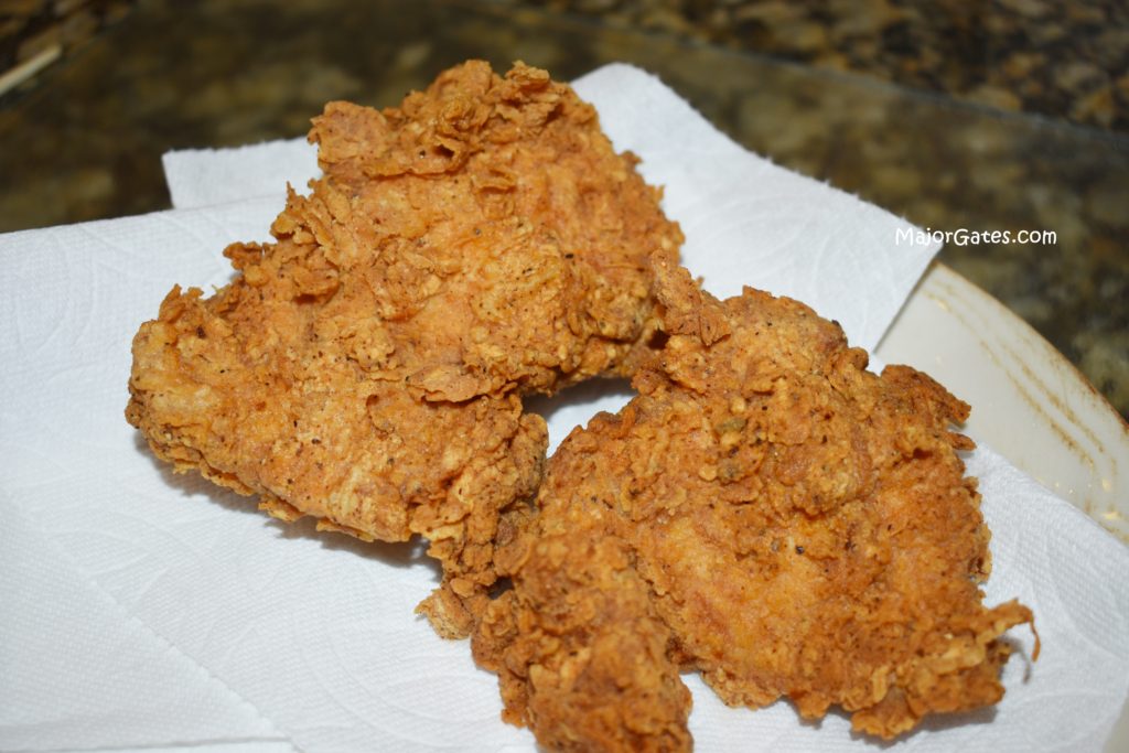 draining fried chicken
