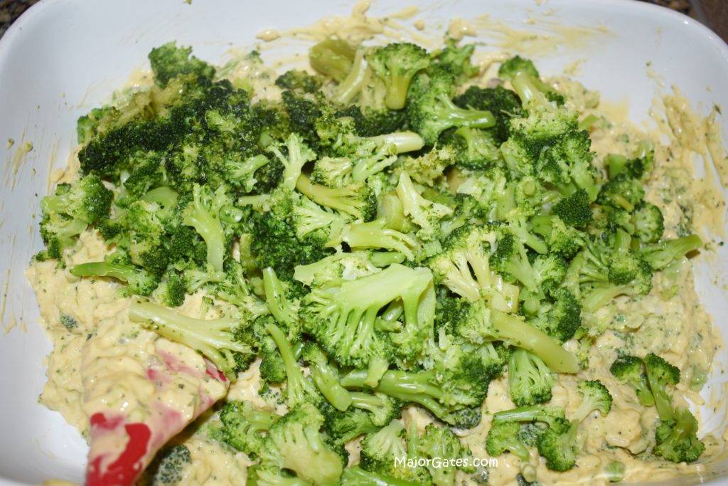 Mixing the broccoli and cheese 